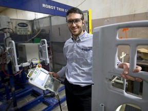 Michael Gordon, plant manager for Exi-Plast in Huron Park, holds a programming tool for a robot that tells cutters how to shape and cut holes in blow-molded plastics such as the hospital bed part he?s holding,  The company, which has struggled to find new staff, hopes to find new workers at a London job fair Jan. 27. (MIKE HENSEN, The London Free Press)