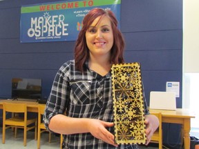 Amanda Knight, with the Makerspace at the Sarnia Public Library, downtown, holds a wine box created with a laser cutter. The Makespace program, introduced at the library two years ago, has been popular with patrons and has since expanded with a mobile program taking machines to other Lambton County Library branches. (Paul Morden/Sarnia Observer)