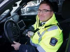 Luke Hendry/Postmedia Network
Hastings-Quinte Paramedic Chief Doug Socha holds his vehicle'’s radio microphone in Bancroft. The service and its partners are ready to launch a pilot project to improve ambulance dispatching between regions but have been waiting a year for provincial approval.