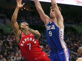 Toronto Raptors guard Kyle Lowry lets a shot go as he is fouled by 76ers forward Dario Saric during the second half of their NBA game in Philadelphia on Monday. Lowry had a rough time in his return from injury and the Raps lost 117-111. (The Associated Press)