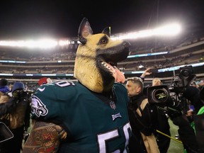 Philadelphia Eagles defensive end Chris Long dons a dog mask, embracing the underdog role, after their 15-10 win over the Atlanta Falcons in the NFC divisional playoff game at Lincoln Financial Field in Philadelphia on Saturday.