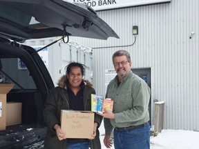The Cochrane Food Bank and Aileen Wright English Catholic School have been a huge supporters of the Tungol Primary School Library Project. Symone Dawanincura is seen with Claude Rocheleau of the Food Bank with many of the boxes of books donated from the school and purchased from the facility.