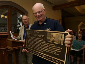 Intelligencer file photo
Richard Hughes (first from left), president of Hastings County Historical society and Bill Kennedy, showcase one of the plaques installed commemorating local history in Belleville. The plaque program continues this year with installations planned at sites in Marmora, Tyendinaga, Bancroft and others.