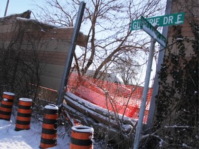 A truck travels west along Highway 402 Wednesday, visible through a break in the sound barrier wall where Hollands Avenue meets Guthrie Drive East in Sarnia. Police are investigating a crash that caused the break Jan. 7. A Transportation Ministry official said repairs are expected to take at least three weeks.  (Tyler Kula/Sarnia Observer)