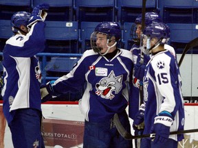Sudbury Nickel Capital Wolves forward Carson McMillan (centre) celebrates a goal with teammates during Great North Midget League action on Saturday, December 2, 2017. Ben Leeson/The Sudbury Star/Postmedia Network