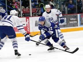 Alexey Lipanov (middle) of the Sudbury Wolves slides between two Mississauga Steelheads players during OHL action at the Sudbury Community Arena in Sudbury, Ont. on Friday, January 12, 2018. John Lappa/Sudbury Star/Postmedia Network