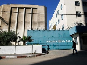 A Palestinian man walks past the building of the UNRWA headquarters in Gaza City on January 8, 2018. MOHAMMED ABED / AFP/Getty Images