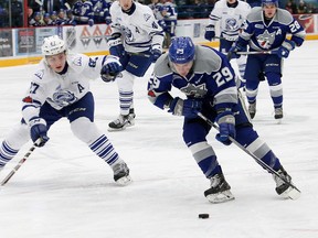 Darian Pilon, right, of the Sudbury Wolves, attempts to skate around Jacob Moverare, of the Mississauga Steelheads, during OHL action at the Sudbury Community Arena in Sudbury, Ont. on Friday January 12, 2018. John Lappa/Sudbury Star/Postmedia Network