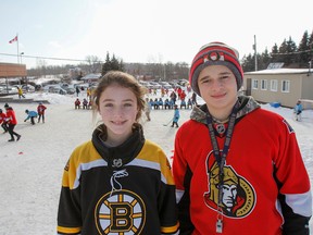 Grade 8 students Samantha Wheeler, a Boston Bruins fan, and Nikolas Saber, an Ottawa Senators fan, are members of the planning team that helped the staff with the organization of the Hockey Day in ALCDSB events on Wednesday. (Julia McKay/The Whig-Standard)