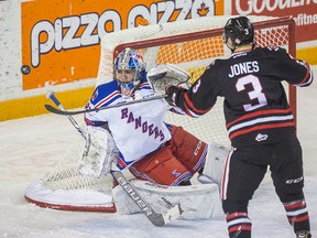 Bob Tymczyszyn/Standard Staff
Kitchener Rangers goalie Mario Culina has his eye on the puck as Niagara IceDogs Ben Jones (3) tries to tip in a loose puck in OHL action Wednesday at Meridian Centre in St. Catharines.