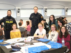 BRUCE BELL/THE INTELLIGENCER
OPP Const. Pat Menard (left) and Prince Edward County firefighter Tim Kraemer are pictured with high school students from PECI, Quinte Secondary and Nicholson during the first C.H.A.T. conference at the Prince Edward Community Centre in Picton on Thursday.