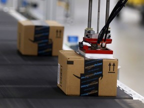 Product is automatically labelled along the conveyor inside the Amazon Fulfillment Centre in Brampton on Friday July 21, 2017. Dave Abel/Toronto Sun/Postmedia Network