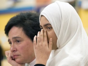 Khawlah Noman wipes a tear from her eye, (Shari Schwartz-Maltz, TDSB spokesperson in back) , and her brother Mohammad Zakarijja appeared before the media with their mom Saima Samad, to talk about the assault that happened to Khawlah on their way to Pauline Johnson Public School in Scarborough. (Toronto Sun)