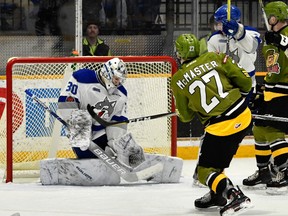 Sudbury Wolves goaltender Jake McGrath makes a save on North Bay Battalion forward Adam McMaster during second-period OHL action at Memorial Gardens in North Bay on Thursday, January 18, 2018. Tom Martineau/For Postmedia Network