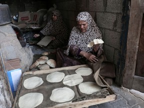 SAID KHATIB/Getty Images
Palestinian refugee women bake bread at their house in the Rafah refugee camp in the southern Gaza Strip on Jan. 17, 2018. The UN agency for Palestinian refugees faces its worst funding crisis ever after the United States froze tens of millions of dollars in contributions, its spokesman said.