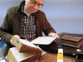 Matt Scholtz examines a 200-year-old bible.