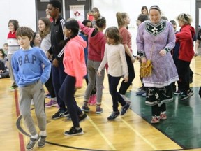 BRUCE BELL/THE INTELLIGENCER
Haudenosaunee dancer Naomi Martin leads students at St. Michael Catholic School through the Presentation dance. Derek and Naomi Martin from Six Nations near Brantford, spent the week at the east-end elementary school teaching Haudenosaunee dance, music and culture to students in Grades 3 to 8.