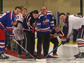 Members of the Austims Aspergers Friendship Society of Calgary were the special guests for a ceremonial puck drop at the Stony Plain Flyers and Spruce Grove Regals game on Jan. 12. The society attended the game and visited with players afterwards to thank the teams for donating jerseys to their newly formed ball hockey league.(Keenan Sorokan/Stony Plain Reporter)