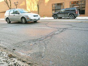 A vehicle passes by cracks in the road on Fifth Street in downtown Chatham Jan. 18, 2018. A recent freeze-thaw-freeze is an example of how winter conditions cause damage to roads, according to the Municipality of Chatham-Kent's director of engineering and transportation. (Tom Morrison/Chatham This Week)