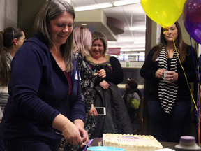 Jody Tucker, founder of the Spruce Grove after-hours Gay-Straight Alliance, cuts a cake during an opening celebration at the Spruce Grove Public Library on Jan. 11. Local dignitaries, including Spruce Grove Mayor Stuart Houston and Spruce Grove — St. Albert MLA Trevor Horne, were in attendance. - Photo by Jesse Cole