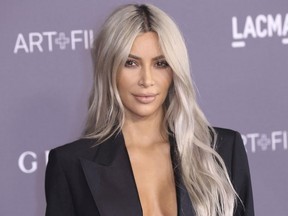 FILE - In this Nov. 4, 2017 file photo, Kim Kardashian West arrives at the LACMA Art + Film Gala at the Los Angeles County Museum of Art in Los Angeles. West is promoting Screenshop, which dishes up a range of shoppable fashion and accessory options based on a phone screen grab a user takes from social media or anywhere else.