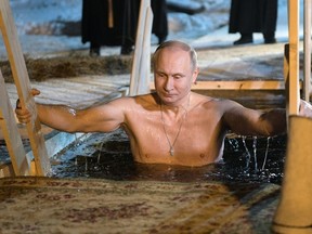 Russian President Vladimir Putin bathes in an ice-cold water on Epiphany neat St. Nilus Stolobensky Monastery on Lake Seliger in Svetlitsa village, Russia, Friday, Jan. 19, 2018. Alexei Druzhinin / AP