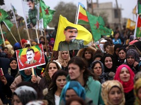 Syrian-Kurds carry portraits depicting jailed leader of the Kurdistan Worker’s Party Abdullah Ocalan, as they protest in Jawadiyah. Syria, after Turkish President Recep Tayyip Erdogan vowed to launch an operation against towns in Syria held by the Kurdish People’s Protection Units, which Ankara considers “terrorists.” (DELIL SOULEIMAN/Getty Images)