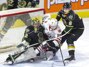 Knights defenceman Riley Coome forces Niagara Ice Dogs forward Oliver Castleman into London goalie Joseph Raaymakers during the first period of their OHL game at Budweiser Gardens on Friday night. (DEREK RUTTAN, The London Free Press)