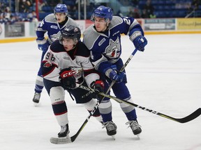 Peter Stratis, right, of the Sudbury Wolves, and Damien Giroux, of the Saginaw Spirit, battle for position during OHL action at the Sudbury Community Arena in Sudbury, Ont. on Friday January 19, 2018. John Lappa/Sudbury Star/Postmedia Network