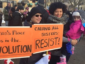 Donna Moser, left, and Mercedes Morgan, holding her two-year-old daughter, Alexandra, attend the women?s rally in Victoria Park. Similar rallies were held in Stratford, Sarnia and in cities around the world on the weekend to mark the first anniversary of the swearing-in of U.S. President Donald Trump and a massive women?s march in Washington that followed. (NORMAN DE BONO, The London Free Press)