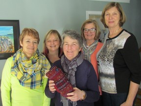 Members of 4Friends Plus, from left, Shirley Vanderweilen, Arlene Duckert, Laurie Hardy, Karen King and Marion Burr, are shown with a pair of the mittens they make and sell as a fundraiser for Community Liviing Sarnia-Lambton. Not pictured here is the sixth member, Wilma Maher.
 Paul Morden/Sarnia Observer/Postmedia Network