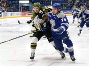 Jesse Saban, left, of the North Bay Battalion, knocks Kirill Nizhnikov, of the Sudbury Wolves, off the puck during OHL action at the Sudbury Community Arena in Sudbury, Ont. on Saturday January 20, 2018. John Lappa/Sudbury Star/Postmedia Network