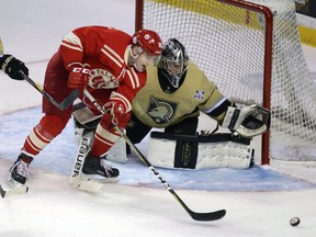 Royal Military College Paladins Scott Emerson can't grab the puck in front of Army Black Knights goalie Cole Bruns during their annual challenge game at the Rogers K-Rock Centre in Kingston on Saturday, Jan. 20, 2018, part of the longest running international hockey series. Army won 5-0, stretching its lead in the series to 46-29-7. (Ian MacAlpine/The Whig-Standard)