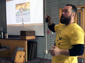 Harley Gallagher, vice-president of the Limestone Beekeepers Guild, answers questions during a talk on beekeeping at Kingston Frontenac Public Library’s Isabel Turner Branch on Saturday. (Steph Crosier/The Whig-Standard/Postmedia Network)