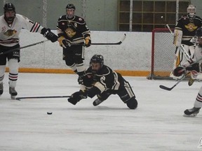 Noah Nurse diving to swipe the puck away from the attacking Hawks. (Courtesy of Linda Stewart)