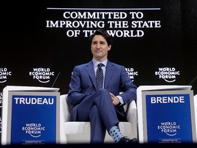 Justin Trudeau, Prime Minister of Canada, sits on the podium prior to his special address on corporate responsibility and the role of women in a changing world during the annual meeting of the World Economic Forum in Davos, Switzerland, Tuesday, Jan. 23, 2018. (AP Photo/Markus Schreiber)