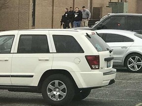 Police escort a person, second from right, out of the Marshall County High School after a shooting there, Tuesday, Jan 23, 2018, in Benton, Ky. Dominico Caporali via AP