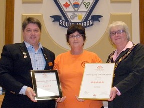 South Huron Communities in Bloom chairperson Cathy Seip, centre, presents plaques to Coun. Craig Hebert, left, and Mayor Maureen Cole, right, recognizing South Huron for achieving “5 Blooms” in the 2017 national Communities in Bloom competition. Special mention was also given to the Exeter downtown parkette. (Scott Nixon)