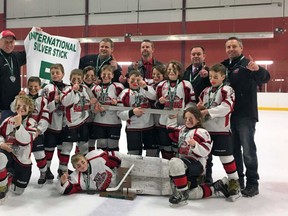 The Novice Rep. Sabres claimed International Silver Stick gold on the weekend of Jan. 14 in Pelham, Ont. Above the team celebrates. Back row from (l-r) are: assistant coach Derek McLaughlin, trainer Marty Debruyn,head coach Derrick Leenders, assistant coach Jeff Kerslake and assistant coach Paul Grant. Third row from (l-r) are: Cullen Kerslake and Ryan Obre. Second row from (l-r) are:  Kallen Grant, Cole Smale, Myles Phillips, Kane Barch, Drew Kramer, Hudson Leenders and Basil McLaughlin. Front row from (l-r) are Jesse Debruyn, Logan Morley and Jack Taylor. (Handout/Exeter Lakeshore Times-Advance)