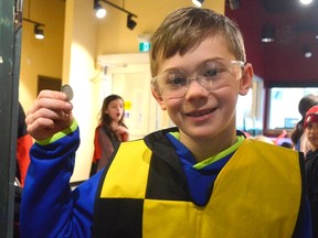 Student Cameron Reichelt holds a coin crafted with tools at the medieval exhibit at the new Elgin County Heritage Centre. The museum will be more hands-on in an effort to attract classes from around the St. Thomas, Elgin County, and London area. (Louis Pin // Times-Journal)