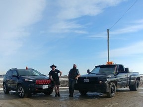 Jesse (right) and Josh, of Blyth, with their trusty roadside rescue vehicles. The men have used their SUV and truck, both equipped with caution lights and towing apparatus, to assist several drivers in need this winter. They hope to continue to serve the community in their own unique way. (PHOTO COURTESY OF JESSE BAARDA)