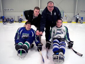 Sledge hockey coaches Kevin Madden (left) and Walt Molinaro at centre ice with players Nick Heightington (left) and Haris Karagic before a junior level exhibition game at Western Fair Sports Centre. (Chris Montanini\Londoner)