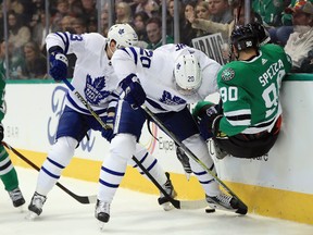 Jason Spezza of the Stars gets knocked to the ice by Leafs Dominic Moore while Travis Dermott collects the loose puck Thursday night in Dallas. (Photo by Ronald Martinez/Getty Images)