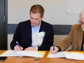 Gateway Director, Jay McFarlan with Chris Lee Vice Chair of G2G Rail Trail, signing a Memorandum of Understanding. (Kathleen Smith/Goderich Signal Star)