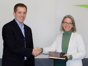 Gateway Director Jay McFarlan officially presenting Professor Heather Mair as the new Research Chair for Gateway. (Kathleen Smith/Goderich Signal Star)