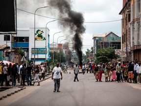 JOHN WESSELS/Getty Images
People look on during a demonstration calling for the president of the Democratic Republic of the Congo (DRC) to step down on Jan. 21in Kinshasa. At least one person was killed in Kinshasa on Jan. 21 after security forces opened fire to disperse protesters at a banned march demanding that President Joseph Kabila stand down, the UN and witnesses said.