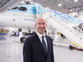 Bombardier president and CEO Alain Bellemare is seen next to a CSeries CS300 ready for delivery to Korean Air Thursday, December 21, 2017 in Mirabel, Que. THE CANADIAN PRESS/Paul Chiasson