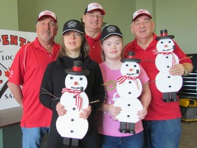 The Carpenters Union Local 1256 and the Down Syndrome Association of Lambton County have teamed up to organize an event at the union hall Tuesday where 25 young people will make ornamental wooden snowmen. From left, Gord MacDonald, Sydney Vrolyk, Garry Cannon, Morgan M'Hoogie, and Alex Ralph. (Paul Morden/Sarnia Observer)