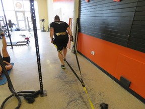 Farr Ramsahoye/Supplied Photo
Jan Murphy performs a sled pull variation during a training session with Farr Ramsahoye of Visionary Fitness at 247 Fitness Solutions this week. This is the power production or conditioning portion of Jan’s training, he must not only have strength but the ability to perform heavy tasks safely, dynamically, and over a sustained period of time.