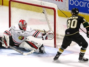 Knights forward Alex Formenton flips a rolling puck over the glove hand of Owen Sound Attack goalie Mack Guzda after picking up a perfect end boards bank shot by London defenceman Evan Bouchard to opening the scoring during the first period of their OHL game at Budweiser Gardens on Friday night. The Knights won 7-4. (MIKE HENSEN, The London Free Press)